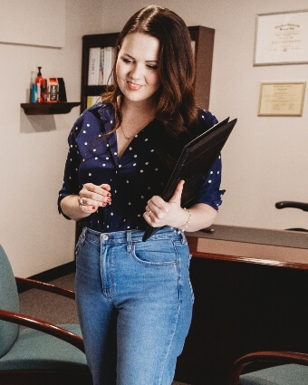 Dr. Stacia holding documents