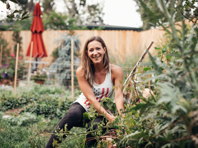 Nikki in the garden picking fresh veggies