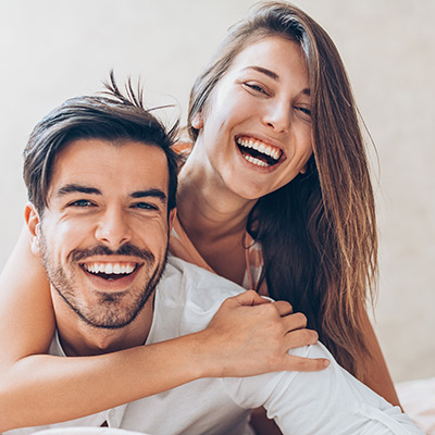 man and woman sitting together smiling