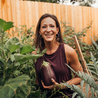 Nikki picking an eggplant