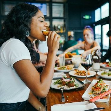 woman in white shirt eating