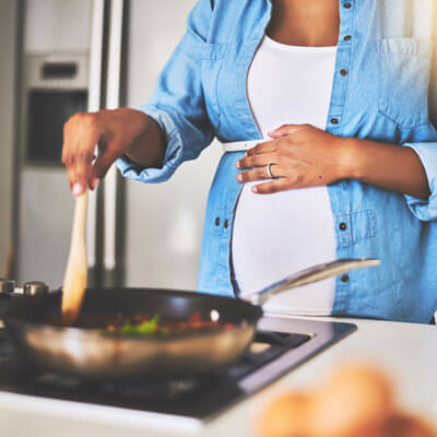 pregnant-woman-cooking-at-stove-sq-400