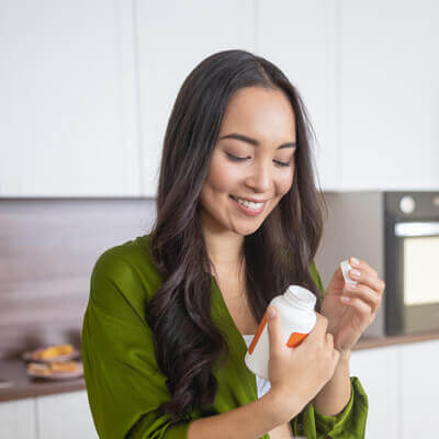 woman-inspecting-supplement-bottle-sq-400