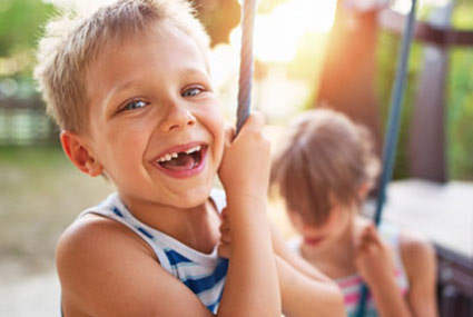 young boy with toothless grin