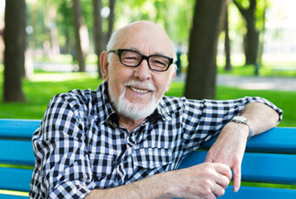 man sitting on bench and smiling