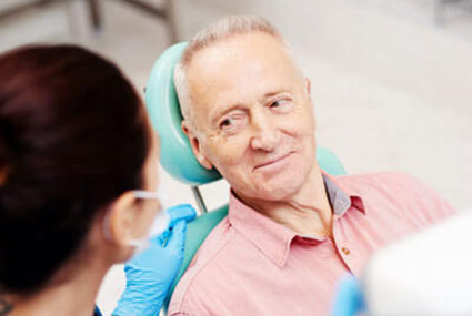 man talking with dental technician