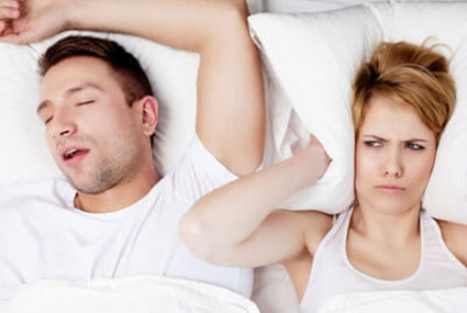 person snoring in bed