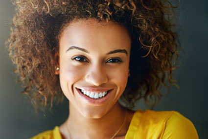 person in yellow shirt smiling