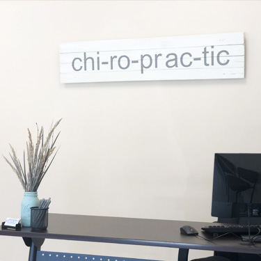 Desk with chiropractic sign