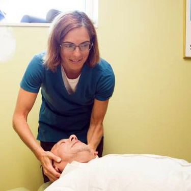 Dr. Elizabeth adjusting mans neck