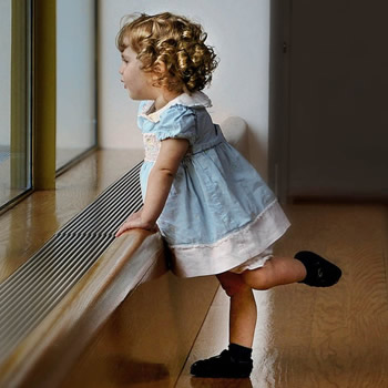 child leaning with one leg up