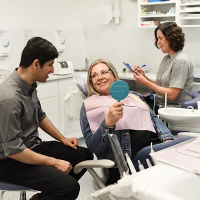 Dr Ohri with patient and dental assistant