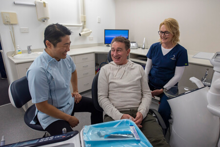 Dr Choi and assistant talking to patient