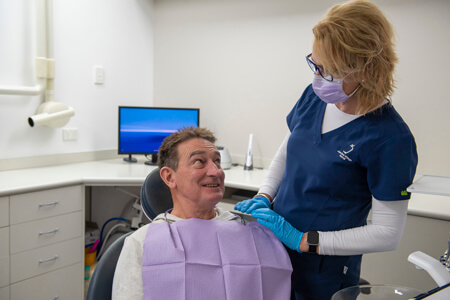 Dental hygienist with patient