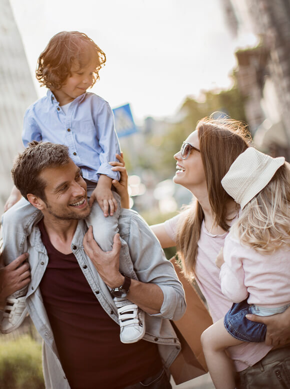 family with boy on dads shoulders