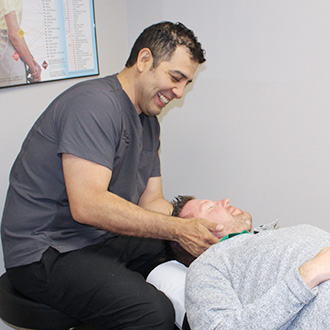 Dr. Aguayo adjusting patient neck