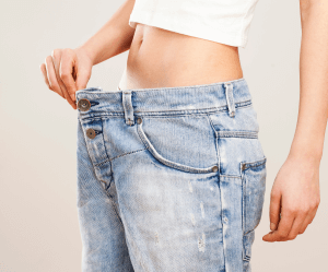 woman holding pants for weight loss