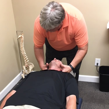 Dr Massey adjusting mans neck