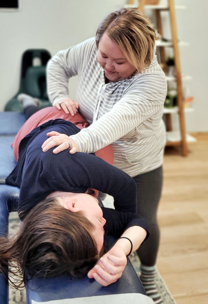 Pregnant woman getting chiropractic adjustment