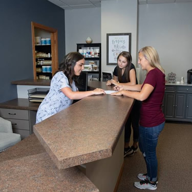 Women standing at reception desk