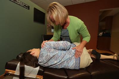 Dr. Becker adjusting woman