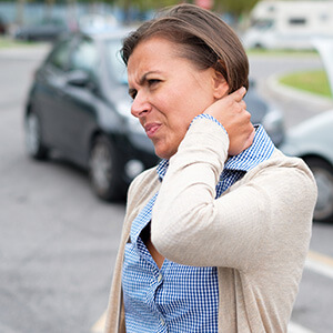 Woman holding neck after auto accident