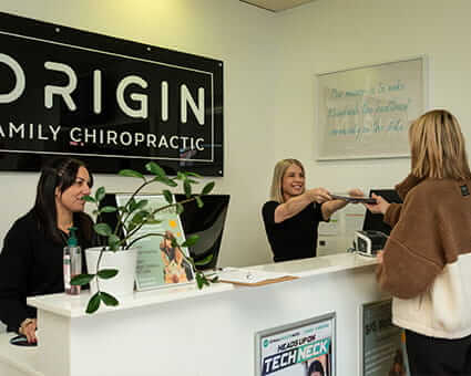 Falcon patient checking in at Origin Family Chiropractic