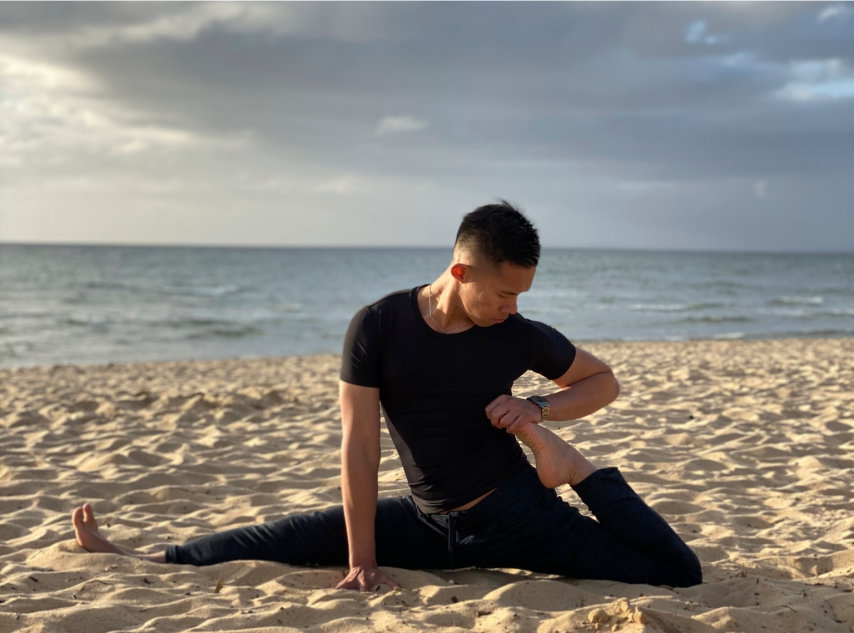 Man down on the beach doing yoga