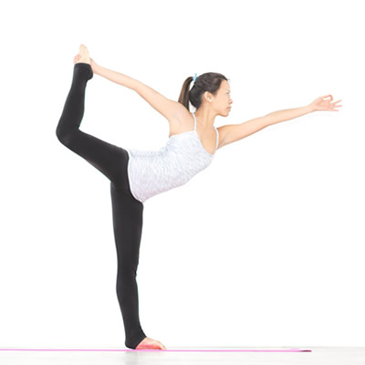 woman standing doing yoga pose