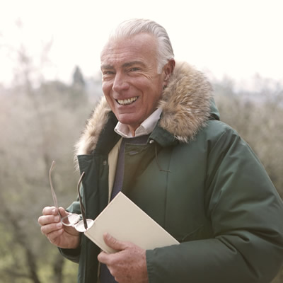 Matured man smiling wearing winter coat