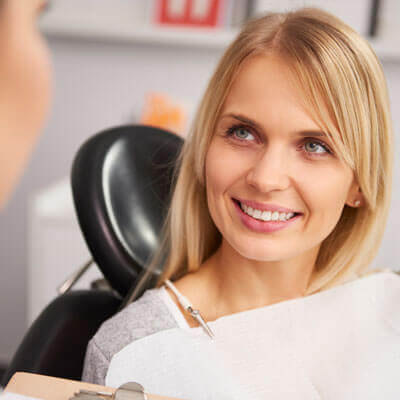 woman-listening-to-dental-assistant-sq