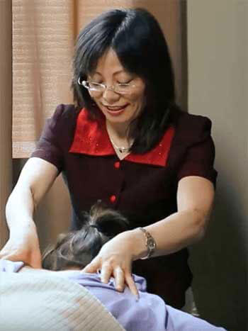 Acupuncturist with hands on back