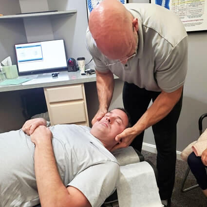 Adjusting patient's neck