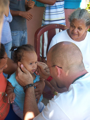 Dr. Matt looking at young child