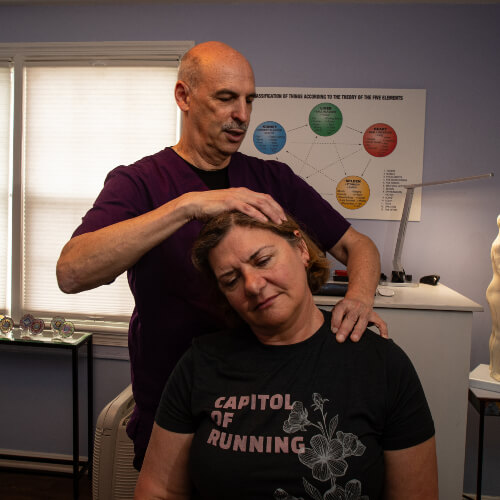 Female patient getting her neck adjusted
