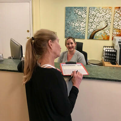 Patient handing in paperwork