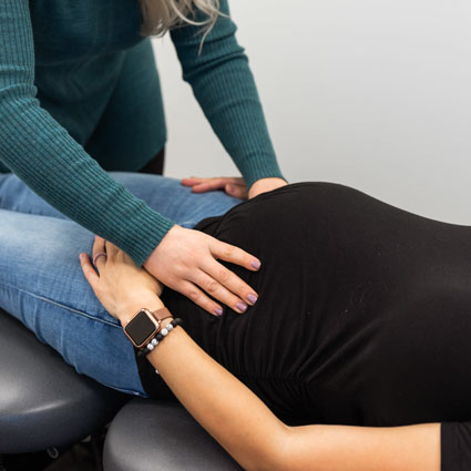 Pregnant woman on adjusting table