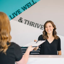 receptionist handing out paperwork