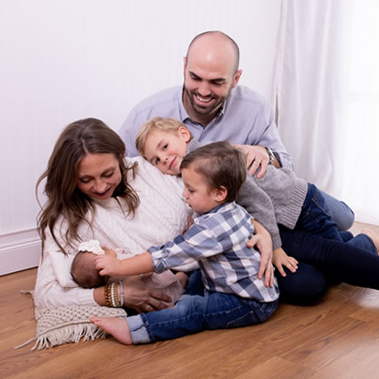 Dr Jake with family and new baby