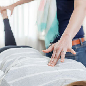 female-chiropractor-adjusting-patient-sq-300