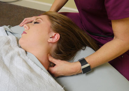Massaging woman's neck