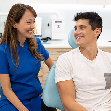 Dr Gisele with male patient white smile