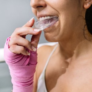women putting in mouthguard