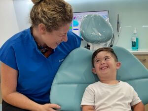 Woman on sofa with tooth pain