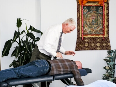 Integrative Chiropractic Chiropractor Dr. Peter Fisk with patient on adjusting table