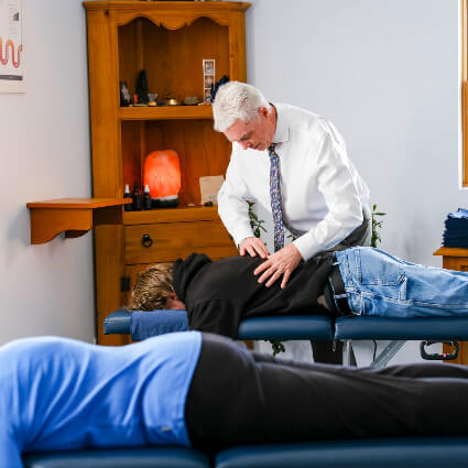 Chiropractor doing Lower back adjustment