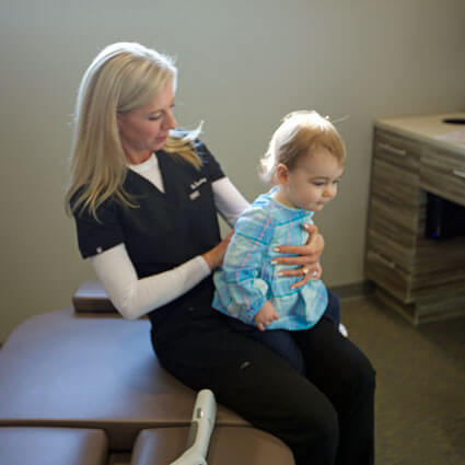 Dr. Townley adjusting toddler