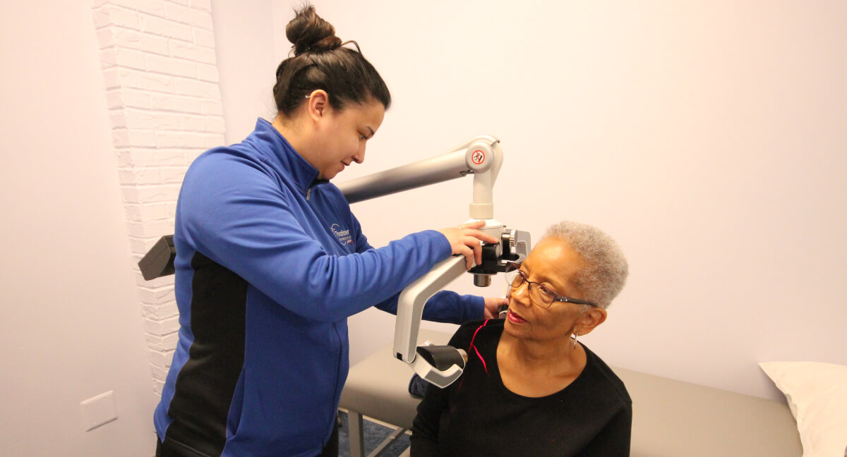 Female patient receiving laser therapy treatment