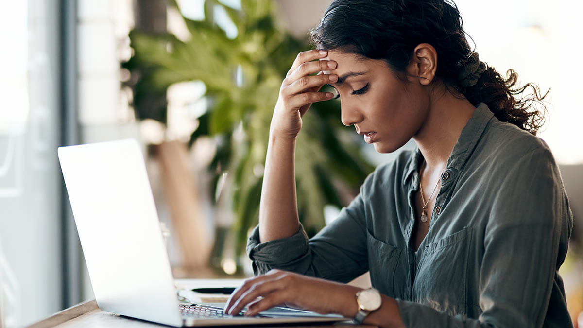 Woman with headache at desk
