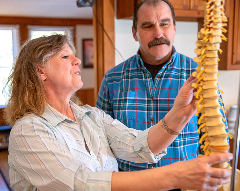 Dr. Amy showing man spine model